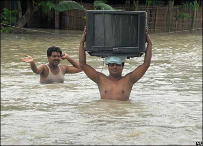 Bangladeshis try to save possessions during flooding in 2007; photo - AP