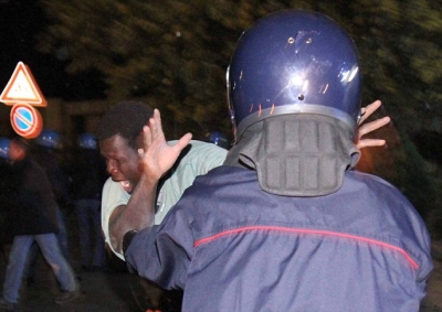 Police clash with immigrants during January's riots in Rosarno, southern Italy